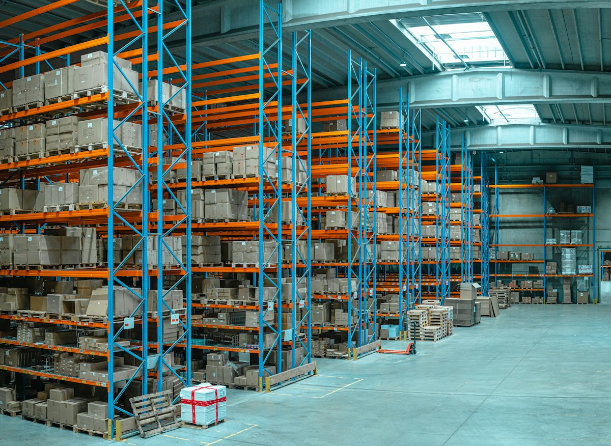 Tall blue shelving units filled with cardboard boxes