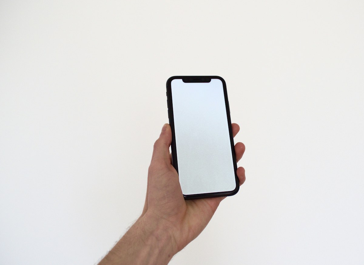 A person holding a phone in one hand