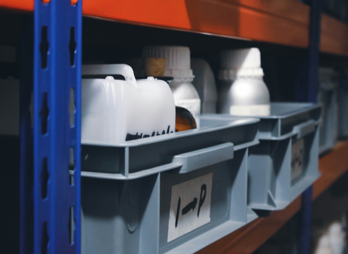 A shelf filled with rows of parts containers