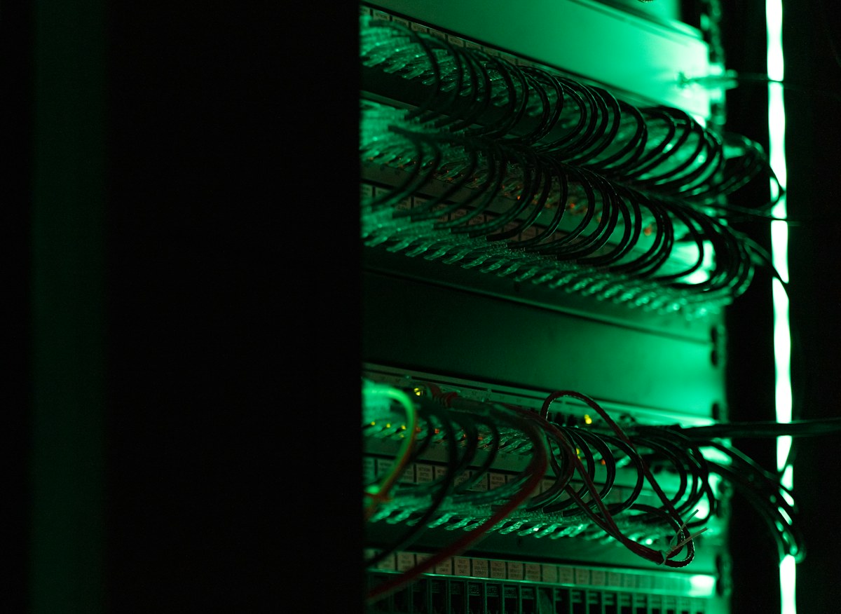 A rack of electronic equipment in a dark room
